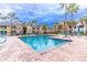 Beautiful community pool with plenty of seating and lots of palm trees surrounding the building at 1057 S Hiawassee Rd # 1911, Orlando, FL 32835