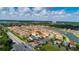 An aerial view of the community showcasing the neighborhood, pond, and beautiful landscaping at 10824 Royal Cypress Way, Orlando, FL 32836