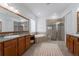 Spacious bathroom featuring double vanity, soaking tub, and walk-in shower with beautiful neutral tile at 10824 Royal Cypress Way, Orlando, FL 32836