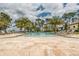 This beautiful community pool is surrounded by lounge chairs and lush palm trees at 10824 Royal Cypress Way, Orlando, FL 32836