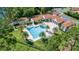 An aerial view of the community pool surrounded by palm trees and lush green landscaping at 10824 Royal Cypress Way, Orlando, FL 32836