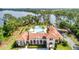 An aerial view of the pool featuring lounge chairs, palm trees, and clubhouse at 10824 Royal Cypress Way, Orlando, FL 32836