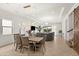 Elegant dining room with a chandelier, tile floors, and sliding glass doors to the outdoor area at 10824 Royal Cypress Way, Orlando, FL 32836