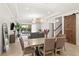 Open concept dining room and living area with a view of the outdoor space and modern decor at 10824 Royal Cypress Way, Orlando, FL 32836