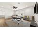 Game room with pool table, bar area, hardwood floors, and comfortable seating area at 10824 Royal Cypress Way, Orlando, FL 32836
