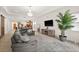 Open concept living area featuring a large sectional sofa, modern decor, and views of the kitchen at 10824 Royal Cypress Way, Orlando, FL 32836