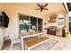 This covered outdoor dining area features a ceiling fan, kitchen, and access to the backyard at 10824 Royal Cypress Way, Orlando, FL 32836