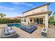 This beautiful backyard is an outdoor oasis complete with a pool, hot tub, and kitchen at 10824 Royal Cypress Way, Orlando, FL 32836