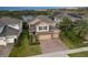 Aerial view of a beautiful home with lush landscaping, brick driveway, and serene lake views at 1416 Cabot Dr, Clermont, FL 34711