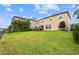 Wide backyard with patio, privacy landscaping, and well-kept lawn, perfect for relaxation and recreation at 1416 Cabot Dr, Clermont, FL 34711