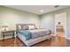 Serene bedroom with hardwood floors, accent lamps, and an en-suite bathroom at 1416 Cabot Dr, Clermont, FL 34711
