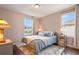 Cozy bedroom with a comfortable bed, plush rug, hardwood floors, and natural light at 1416 Cabot Dr, Clermont, FL 34711