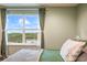 Bedroom showcasing a large window with verdant views of the backyard at 1416 Cabot Dr, Clermont, FL 34711