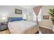 Bedroom featuring a comfortable bed, plush carpet, soft decor, and natural light at 1416 Cabot Dr, Clermont, FL 34711