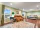 Bright main bedroom offering a relaxing seating area and serene water view at 1416 Cabot Dr, Clermont, FL 34711