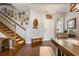 Warm entryway with hardwood floors, staircase, chandelier, and charming decor at 1416 Cabot Dr, Clermont, FL 34711
