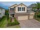 Attractive two-story home with stone accents, manicured landscaping, and a spacious three-car garage at 1416 Cabot Dr, Clermont, FL 34711