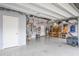Spacious garage with epoxy flooring, overhead storage, and ample room for vehicles and projects at 1416 Cabot Dr, Clermont, FL 34711