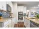 Well-equipped kitchen featuring granite countertops, stainless steel appliances, and a modern mosaic tile backsplash at 1416 Cabot Dr, Clermont, FL 34711