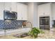 Modern kitchen features granite countertops, stainless steel appliances, and mosaic backsplash at 1416 Cabot Dr, Clermont, FL 34711