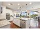 Modern kitchen with stainless steel appliances, granite countertops, and an island overlooking the living and patio areas at 1416 Cabot Dr, Clermont, FL 34711