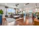 Bright, open-concept living room featuring hardwood floors, a comfortable sectional sofa, and an abundance of natural light at 1416 Cabot Dr, Clermont, FL 34711