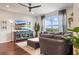 Cozy living space with a sectional sofa, large-screen TV, and bright natural light, perfect for relaxation and entertainment at 1416 Cabot Dr, Clermont, FL 34711