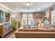 Inviting living room with hardwood floors, modern furnishings, and abundant natural light at 1416 Cabot Dr, Clermont, FL 34711