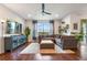 Stylish living room with a large sectional sofa, modern entertainment center, and an inviting view of the outdoors at 1416 Cabot Dr, Clermont, FL 34711