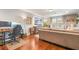 Comfortable living room features hardwood floors, a workstation, and large windows at 1416 Cabot Dr, Clermont, FL 34711