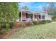 Brick house with covered porch and American flag at 15941 Sw 8Th Pl, Ocala, FL 34481