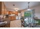 Kitchen with wood cabinets, glass-top table, and backyard access at 15941 Sw 8Th Pl, Ocala, FL 34481