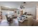 Living room with a curved sofa and ceiling fan at 15941 Sw 8Th Pl, Ocala, FL 34481