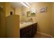 Bathroom with dark brown vanity, large mirror and tile floor at 16307 Old Ash Loop, Orlando, FL 32828