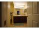 Double sink bathroom with dark wood cabinets and mirror at 16307 Old Ash Loop, Orlando, FL 32828