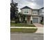 Two-story townhome with attached garage and front landscaping at 16307 Old Ash Loop, Orlando, FL 32828