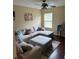 Living room with sectional sofa, ottoman, and wood floor at 16307 Old Ash Loop, Orlando, FL 32828