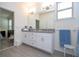 Double vanity bathroom with granite countertop and access to bedroom at 16626 Point Rock Dr, Winter Garden, FL 34787