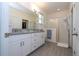 Double vanity bathroom with granite countertops and a walk-in shower at 16626 Point Rock Dr, Winter Garden, FL 34787