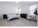 Bedroom with queen bed, dresser, and plenty of natural light at 16626 Point Rock Dr, Winter Garden, FL 34787