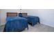 Bright bedroom with two twin beds, blue bedding, and wood-look floors at 16626 Point Rock Dr, Winter Garden, FL 34787