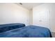 Bedroom with two twin beds, blue bedding, and double doors to closet at 16626 Point Rock Dr, Winter Garden, FL 34787