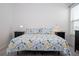 Bright bedroom with a floral comforter and two nightstands at 16626 Point Rock Dr, Winter Garden, FL 34787