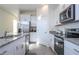 Kitchen with white cabinets, granite countertops, and stainless steel appliances at 16626 Point Rock Dr, Winter Garden, FL 34787