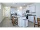 Open kitchen with island, granite countertops, stainless steel appliances, and view into living area at 16626 Point Rock Dr, Winter Garden, FL 34787
