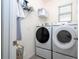 Laundry room with washer, dryer, and shelving for storage at 16626 Point Rock Dr, Winter Garden, FL 34787