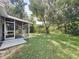 Screened porch overlooks a large backyard with lush grass at 1729 Vivian Ct, Deltona, FL 32725