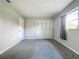 Bright bedroom with grey carpet and window at 1729 Vivian Ct, Deltona, FL 32725