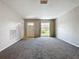 Bright living room with neutral carpeting and large window at 1729 Vivian Ct, Deltona, FL 32725