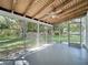 Bright screened porch with wood ceiling and backyard view at 1729 Vivian Ct, Deltona, FL 32725